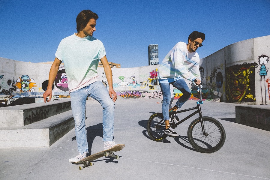The Revenge of Happiness Collection-6 - One man on a skate and other on a bike wearing denim collections
